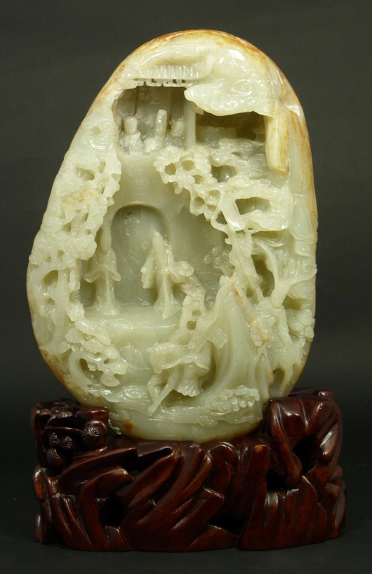 Chinese hand-carved white jade boulder depicting a mountain city scene, 9 3/4 inches tall. Price realized: $21,830. Elite Decorative Arts image.
